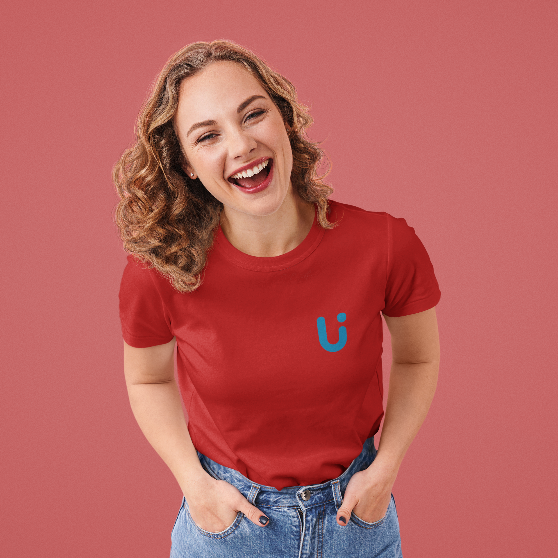 a girl laughing wearing red shirt with U logo pairing with denims